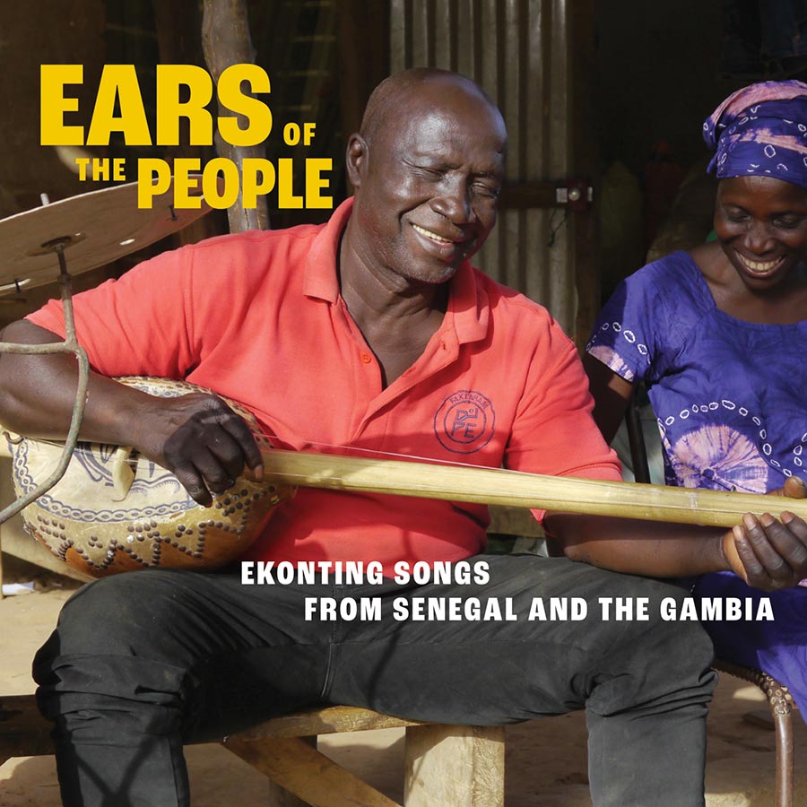 Album cover featuring a man playing a long-necked string instrument. He is sitting next to a woman and they are both smiling.