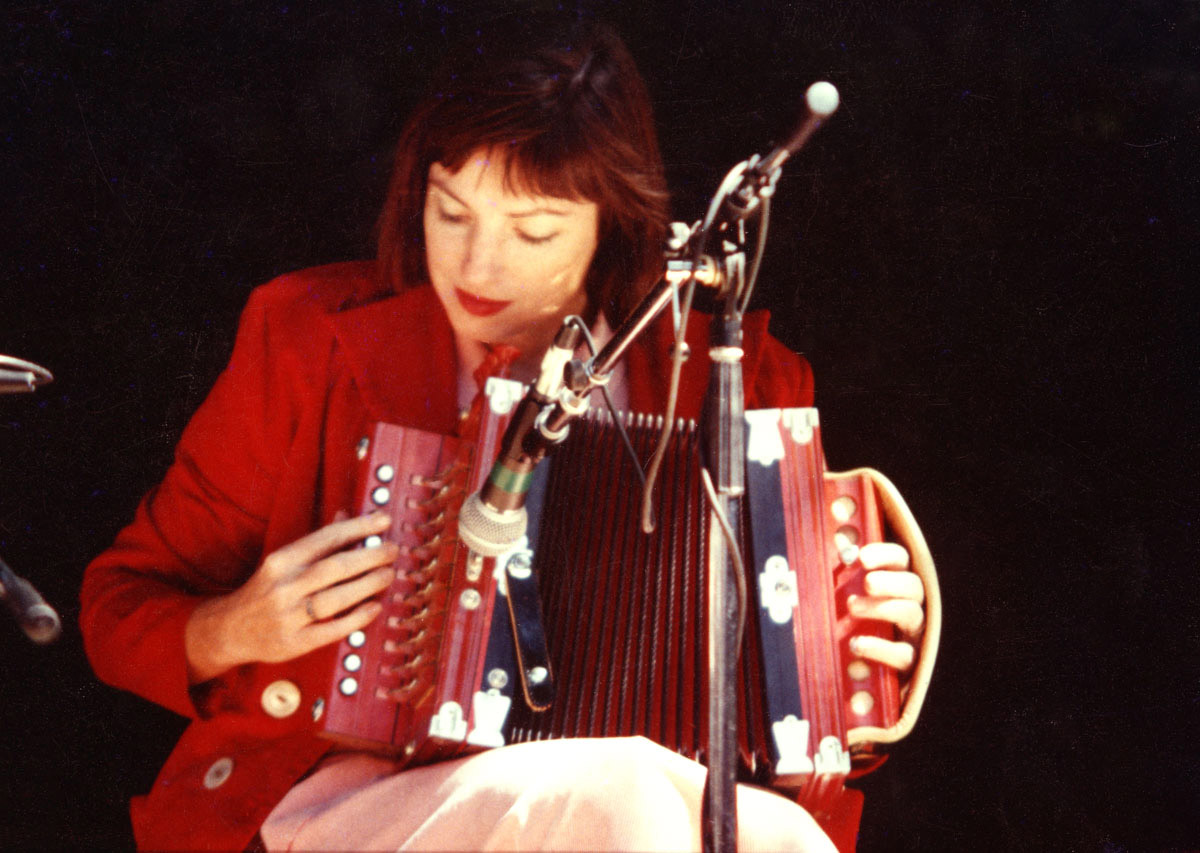 Ann playing red Accordion by Ed McKeon