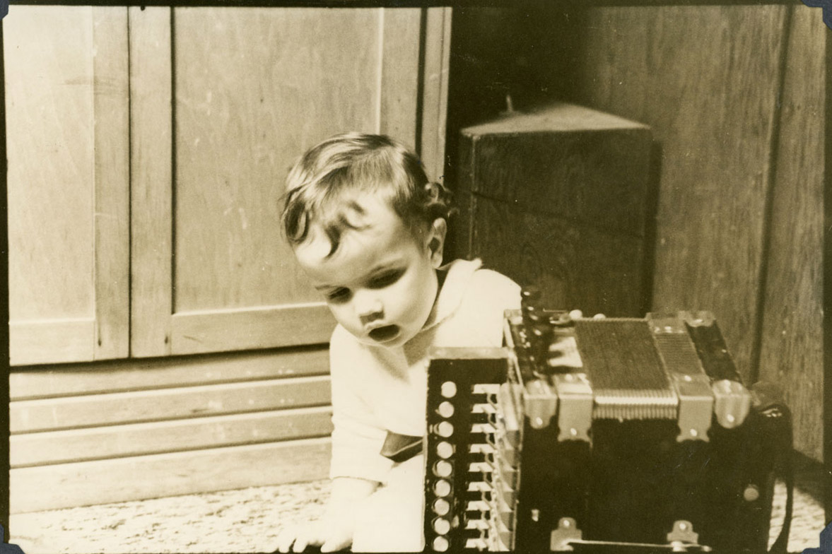 Baby Sarah sneaks up on accordion